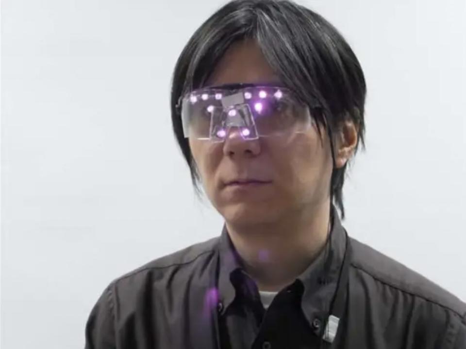 A man wears googles with purple LED lights