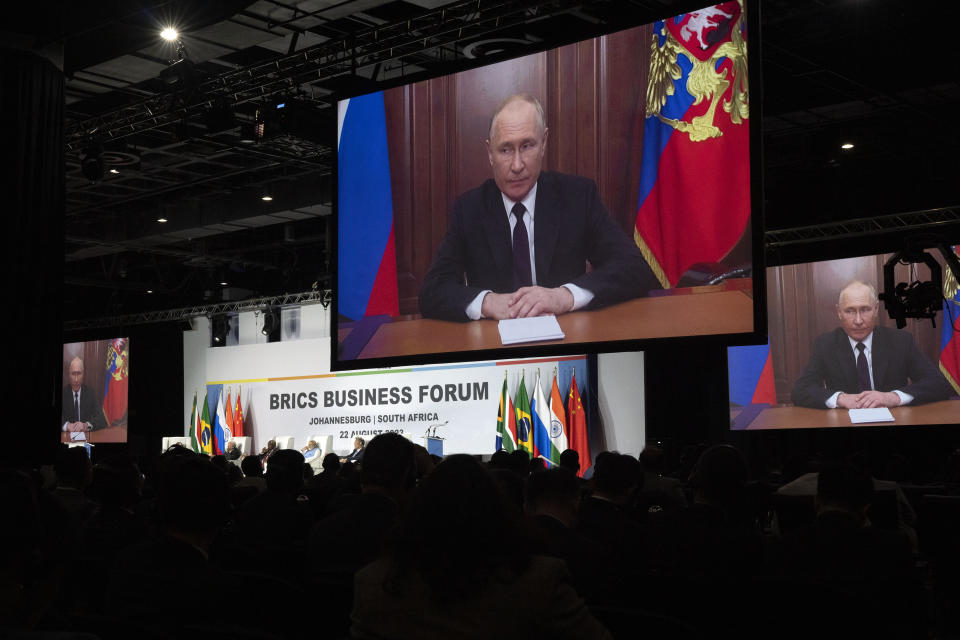 Russian President Vladimir Putin addresses leaders from the BRICS group of emerging economies at the start of a three-day summit in Johannesburg, South Africa, Tuesday, Aug. 22, 2023. Putin appeared on a video link after his travel to South Africa was complicated by an International Criminal Court arrest warrant against him over the war in Ukraine. (AP Photo/Jerome Delay)