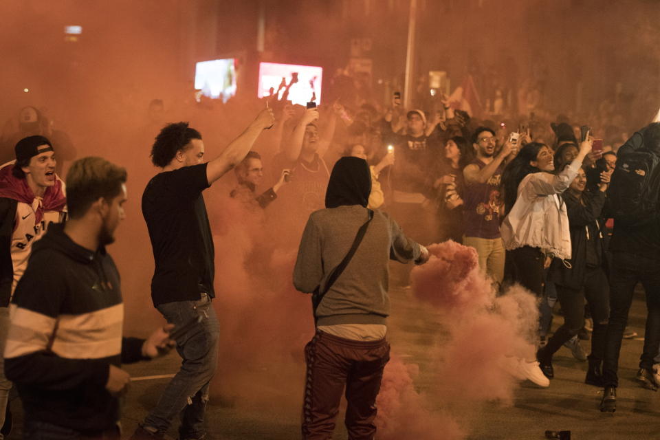 Toronto Raptors fans celebrate in Toronto early Friday, June 14, 2019, following the team's 114-110 win over the Golden State Warriors in Oakland, Calif., in Game 6 of basketball's NBA Finals. (Tijana Martin/The Canadian Press via AP)