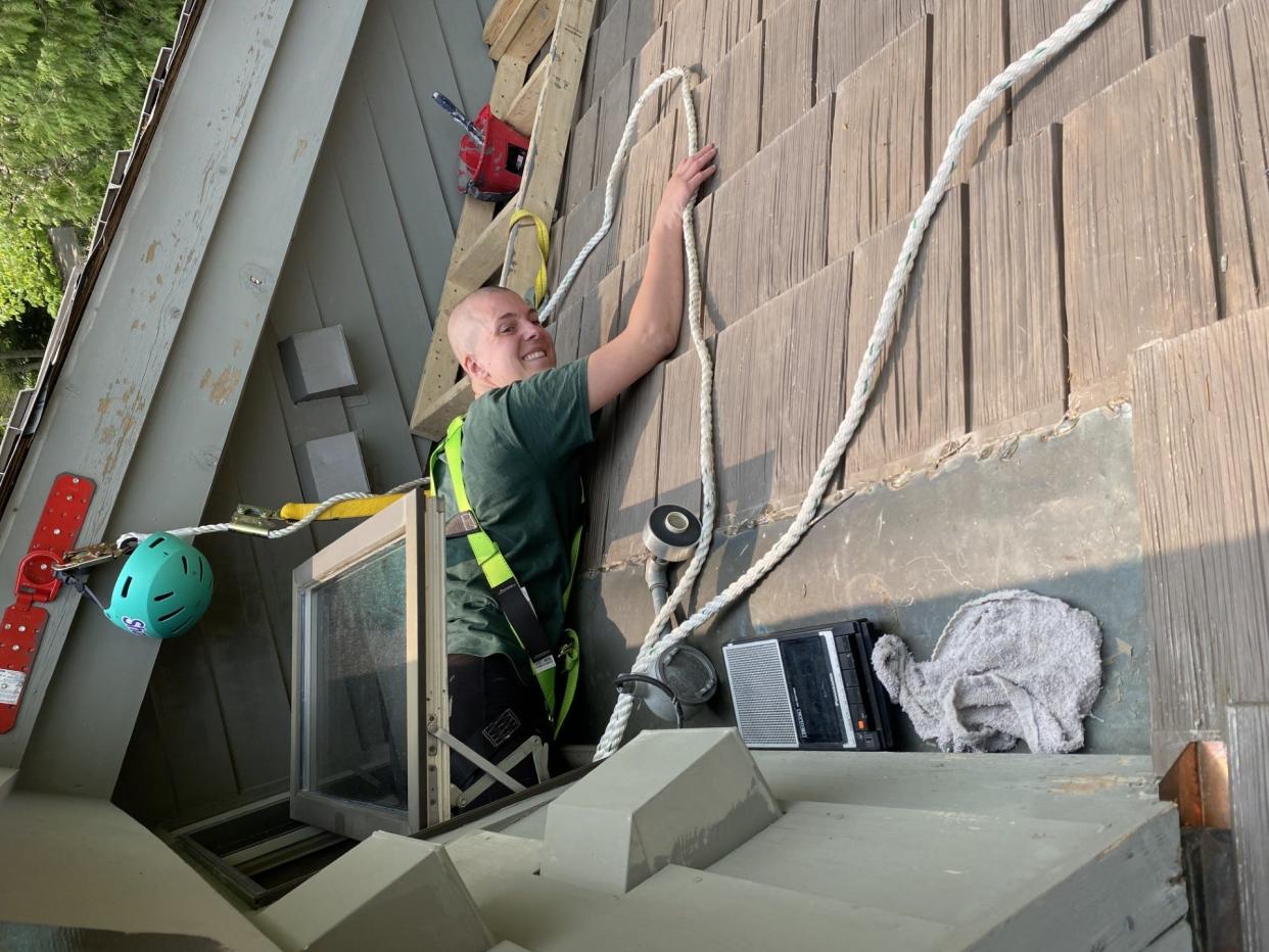 Shawn Buitendorp works on the outside of a home. She and twin Claire have been working in home remodeling for four years after appearing on two different reality television competitions.