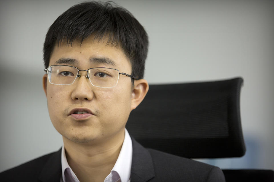 In this Oct. 31, 2018, photo, Huang Yongzhen, CEO of Watrix, speaks during an interview at his company's offices in Beijing. A Chinese technology startup hopes to begin selling software that recognizes people by their body shape and how they walk, enabling identification when faces are hidden from cameras. Already used by police on the streets of Beijing and Shanghai, “gait recognition” is part of a major push to develop artificial-intelligence and data-driven surveillance across China, raising concern about how far the technology will go. (AP Photo/Mark Schiefelbein)