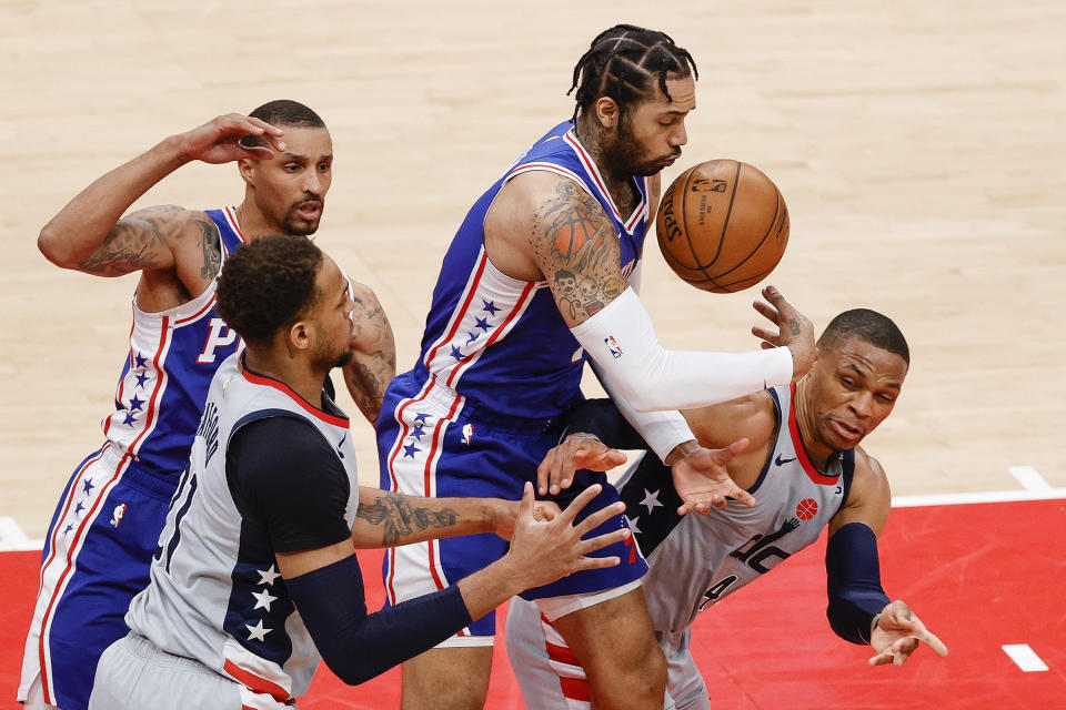 WASHINGTON, DC - MAY 31: Mike Scott #1 of the Philadelphia 76ers and Russell Westbrook #4 of the Washington Wizards reach for the ball during the second quarter during Game Four of the Eastern Conference first round series at Capital One Arena on May 31, 2021 in Washington, DC. NOTE TO USER: User expressly acknowledges and agrees that, by downloading and or using this photograph, User is consenting to the terms and conditions of the Getty Images License Agreement. (Photo by Tim Nwachukwu/Getty Images)