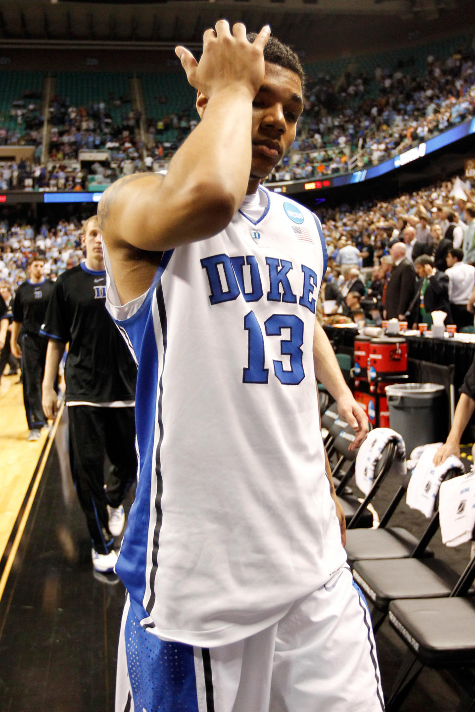 GREENSBORO, NC - MARCH 16: Michael Gbinije #13 of the Duke Blue Devils walks off the court after losing to the Lehigh Mountain Hawks 75-70 during the second round of the 2012 NCAA Men's Basketball Tournament at Greensboro Coliseum on March 16, 2012 in Greensboro, North Carolina. (Photo by Streeter Lecka/Getty Images)