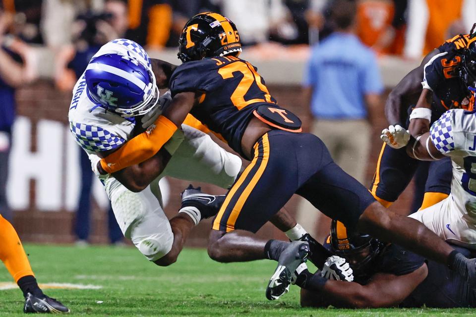 Kentucky running back La'Vell Wright, left, is tackled by Tennessee defensive back Jourdan Thomas (25) during the second half of an NCAA college football game Saturday, Oct. 29, 2022, in Knoxville, Tenn. (AP Photo/Wade Payne)
