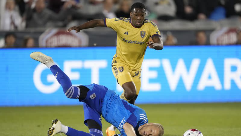 Colorado Rapids goalkeeper William Yarbrough, front, tumbles to the pitch after stopping a shot by Real Salt Lake midfielder Anderson Julio in the second half of an MLS soccer match Saturday, May 20, 2023, in Commerce City, Colo.