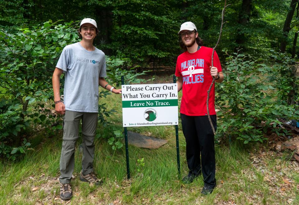 Justin Brown, left, from Yardley, with Jarred Colligon, right, from Bristol, volunteers with Spearhead Project Earth during their weekly cleanup of Burlington Island on the Delaware River in between New Jersey and Pennsylvania on Thursday, Aug. 10, 2023.