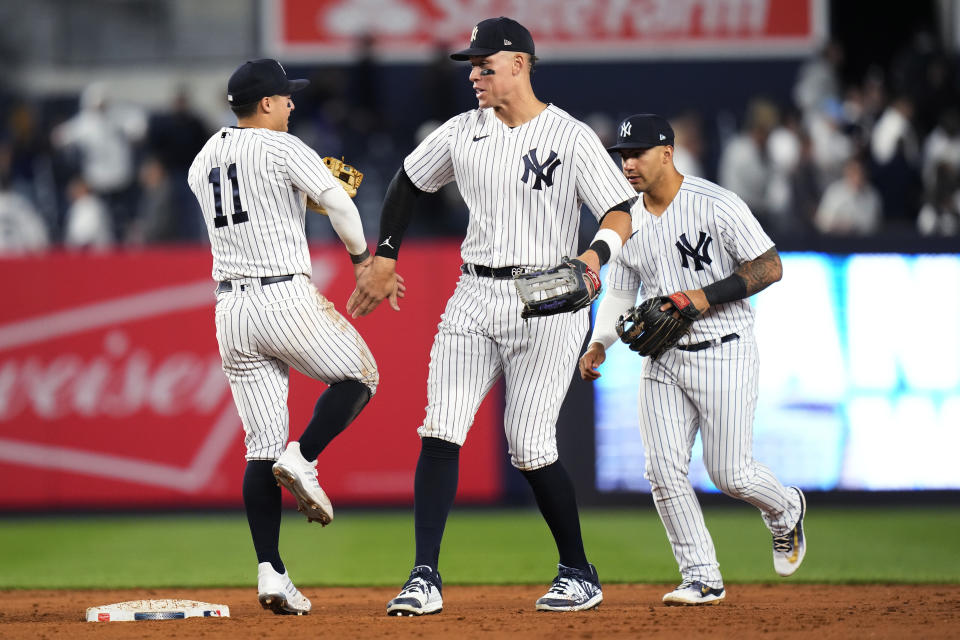 New York Yankees' Aaron Judge, center, celebrates with Anthony Volpe (11) after the team's 10-5 win over the Oakland Athletics in a baseball game Tuesday, May 9, 2023, in New York. (AP Photo/Frank Franklin II)