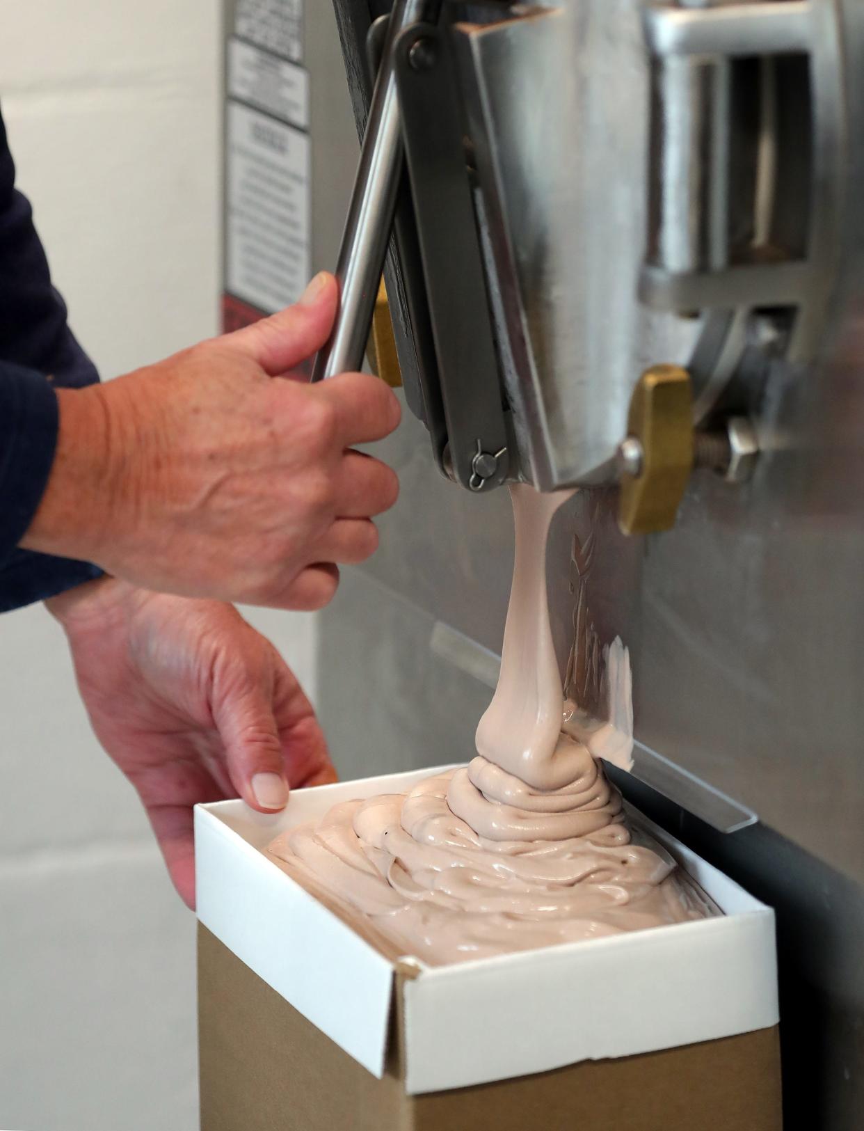Chocolate ice cream pours out from a 10-gallon batch machine before Country Maid in Richfield opens for the day.