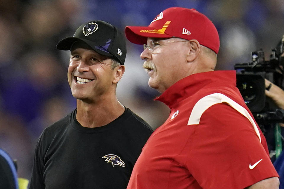 FILE - Baltimore Ravens head coach John Harbaugh, second from left, and Kansas City Chiefs head coach Andy Reid chat before an NFL football game, Sunday, Sept. 19, 2021, in Baltimore. Harbaugh once beat his own brother to win the Super Bowl, so facing a mentor probably won't rattle him. Still, there's plenty of appreciation between the Baltimore coach and Andy Reid, his counterpart on the Kansas City sideline for this week's AFC championship game. (AP Photo/Julio Cortez, File)