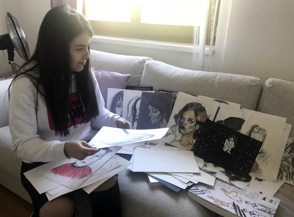 In this Oct. 3, 2018 photo Lilas Almalaki shows her paintings in Vienna, Austria. Lilas Almalaki didn’t know a word of German when she enrolled in an Austrian middle school two months after fleeing her war-torn homeland in 2015, so she relied on the proficient English she learned as a top student in Syria to keep bullies in place. (AP Photo/Philipp-Moritz Jenne)