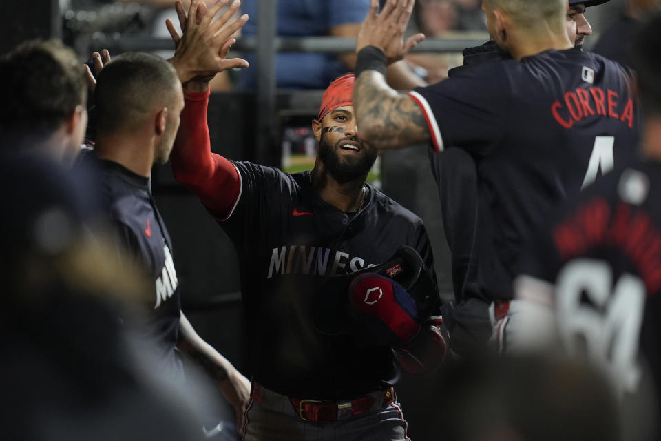 Minnesota Twins' Willi Castro celebrates with teammates in the dugout after scoring on a double from Kyle Farmer during the fifth inning of a baseball game against the Chicago White Sox, Tuesday, April 30, 2024, in Chicago. (AP Photo/Erin Hooley)