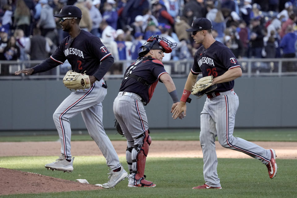 Minnesota Twins' Michael A. Taylor (2), Christian Vazquez and Max Kepler (26) celebrate after their baseball game against the Kansas City Royals Saturday, April 1, 2023, in Kansas City, Mo. The Twins won 2-0. (AP Photo/Charlie Riedel)