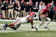 Alabama quarterback Bryce Young (9) run s past Georgia defensive lineman Jalen Carter (88) for a touchdown during the first half of the Southeastern Conference championship NCAA college football game, Saturday, Dec. 4, 2021, in Atlanta. (AP Photo/Brynn Anderson)