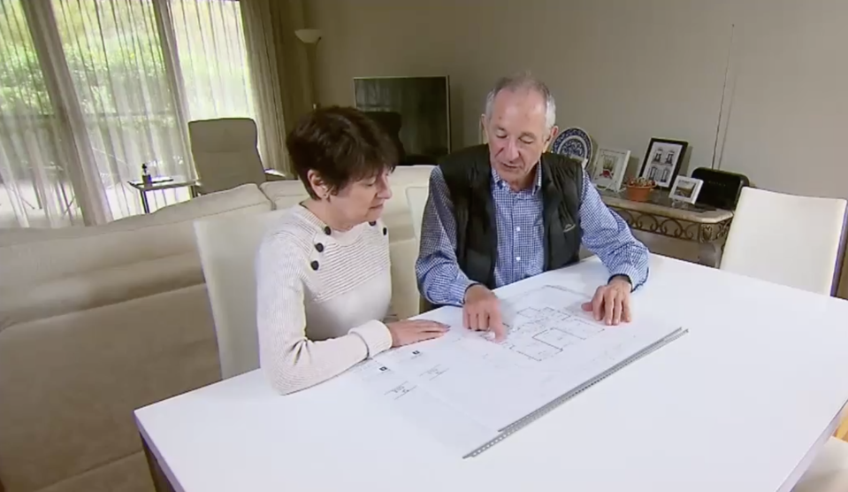 Photo shows Adrian Corp and Lee Katavatis looking over plans for their home they are wanting to build