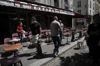 Waiters prepare the terrace of a restaurant in Paris, Monday, June 1, 2020, as France gradually lifts its Covid-19 lockdown. France is reopening tomorow its restaurants, bars and cafes as the country eases most restrictions amid the coronavirus crisis. (AP Photo/Christophe Ena)