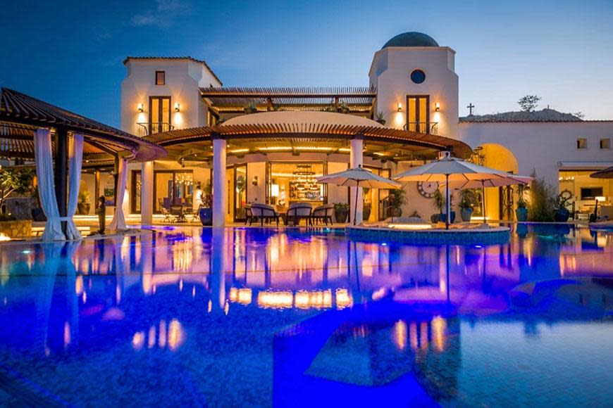 The stunning pool glistens in the night - we just want to dive in!