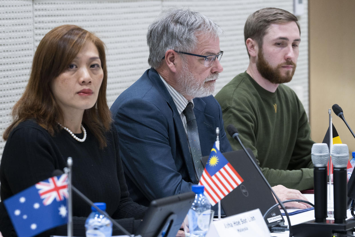 Asha Hoe Soo Lian, Malaysia, Eric van der Sypt, Belgium, and Oleksandr Bannyk, Ukraine, are seen during the Joint Investigation Team, JIT, news conference in The Hague, Netherlands, Wednesday, Feb. 8, 2023, on the results of the ongoing investigation into other parties involved in the downing of flight MH17 on 17 July 2014. The JIT investigated the crew of the Buk-TELAR, a Russian made rocket launcher, and those responsible for supplying this Russian weapon system that downed MH17. (AP Photo/Peter Dejong)