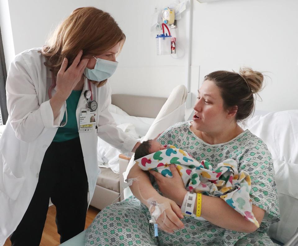 Dr. Katie Clark talks to Brittany Long in the Mother Baby Unit at Cleveland Clinic Akron General.