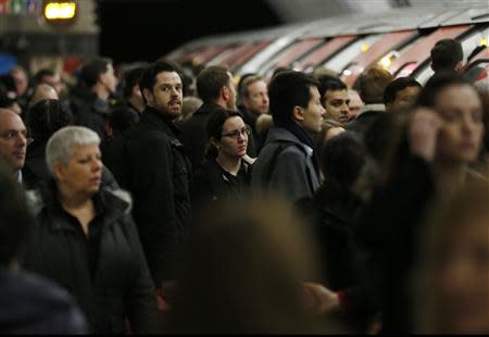 Commuters wait to board a Victoria line tube train during strikes at Kings Cross underground station in London February 6, 2014. REUTERS/Olivia Harris
