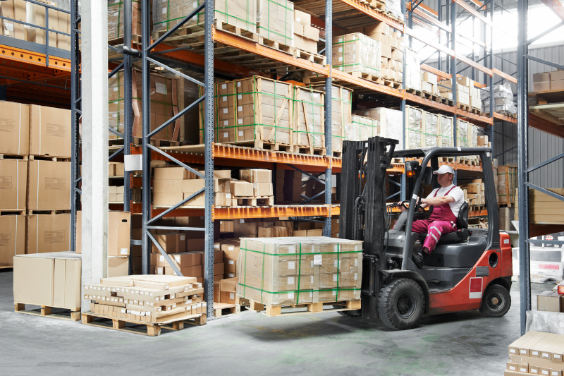 Worker Lifting Goods with Forklift