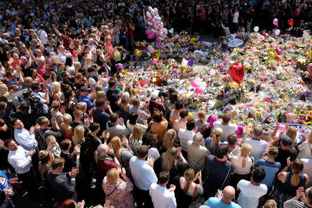 Members of the public attend a minute of silence for the victims of the Manchester Arena attack, in St Ann's Square, in central Manchester, Britain May 25, 2017. REUTERS/Darren Staples