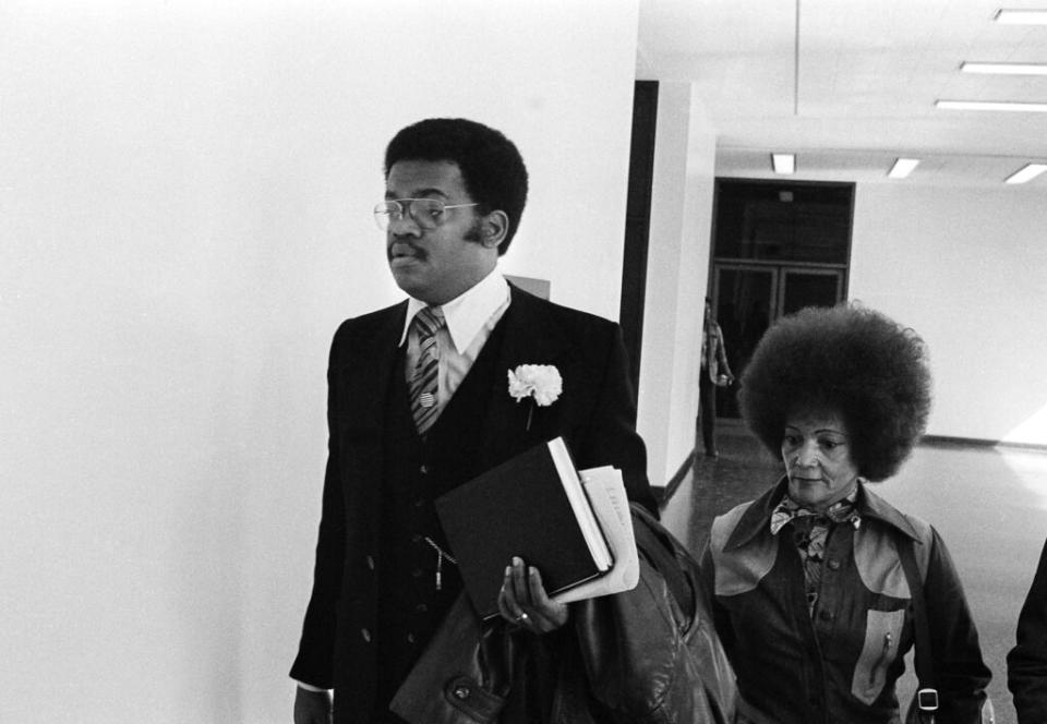 A Black woman and her lawyer leaving court