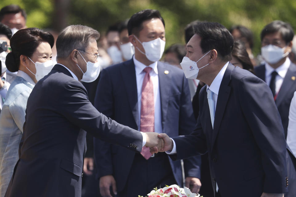 South Korea's new President Yoon Suk Yeol, right, shakes hands with former President Moon Jae-in upon his arrival to his inauguration ceremony at the National Assembly in Seoul, South Korea, Tuesday, May 10, 2022. (Kim Hong-ji/Pool Photo via AP)