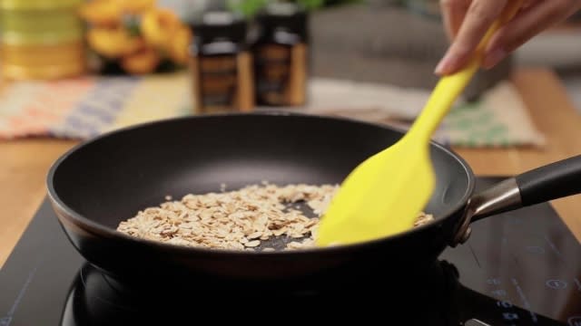 Pan frying rolled oats with spatula