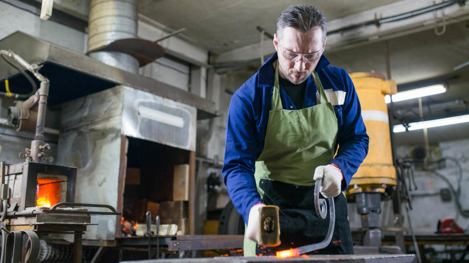 a metalsmith forges metal