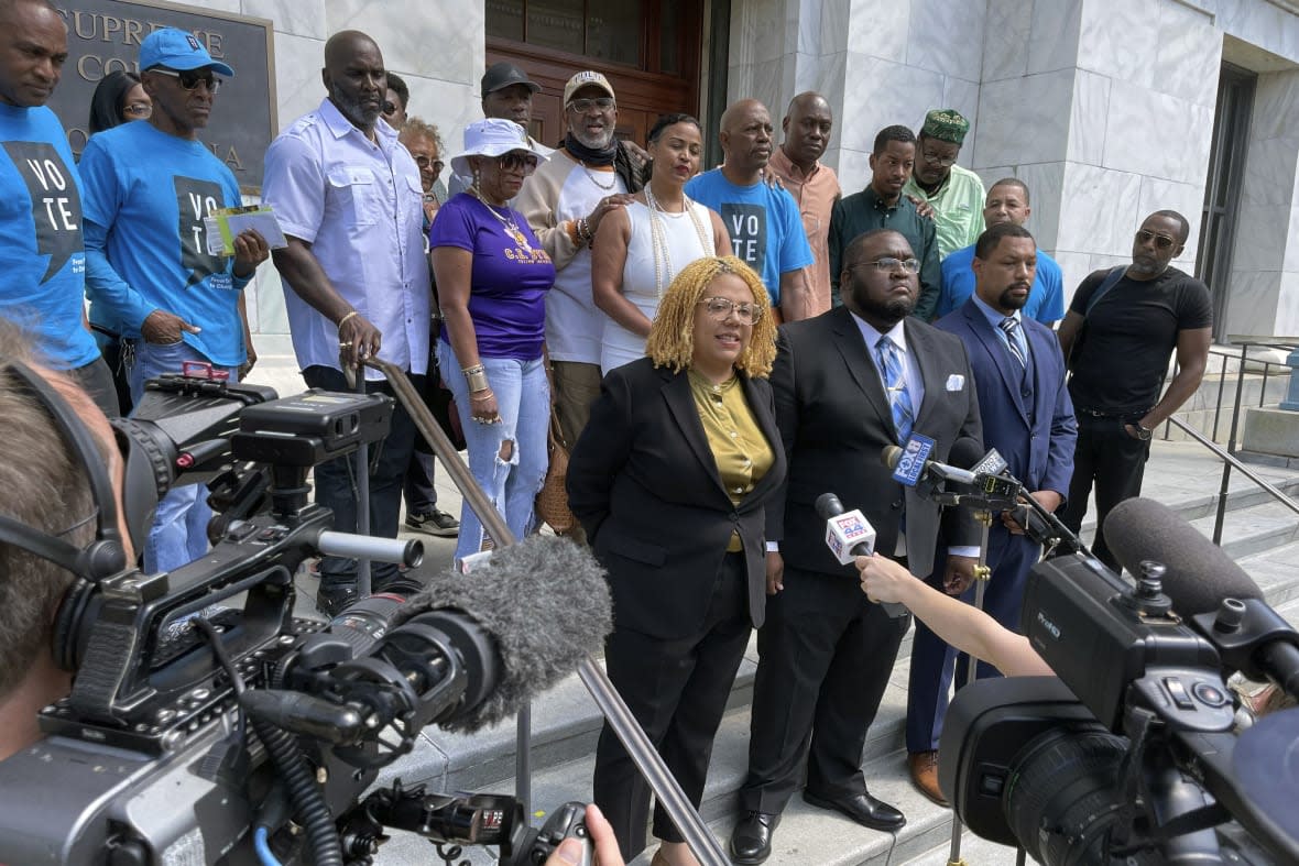Attorneys and criminal justice advocates stand outside Louisiana’s Supreme Court on May 10, 2022, after arguing that people convicted by nonunanimous juries should be granted new trials. (AP Photo/Kevin McGill, File)