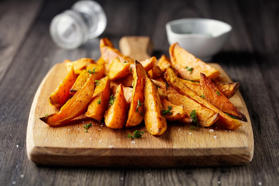 Home made freshness roasted sweet potatoes wedges with garlic herbs