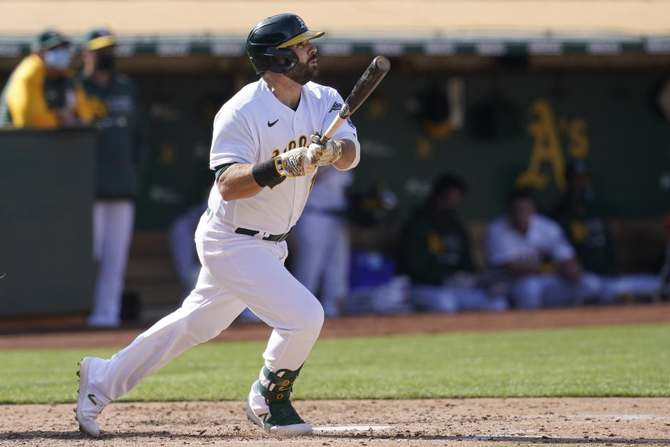 Oakland Athletics' Mitch Moreland watches his solo home run against the Minnesota Twins during the fourth inning of the first baseball game of a doubleheader in Oakland, Calif., Tuesday, April 20, 2021. (AP Photo/Jeff Chiu)