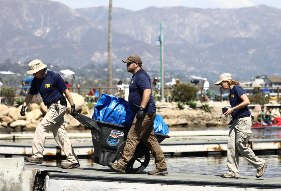 Members of the FBI Evidence Response Team bring material ashore at Santa Barbara Harbor on Sept. 3, 2019 in Santa Barbara, California.
