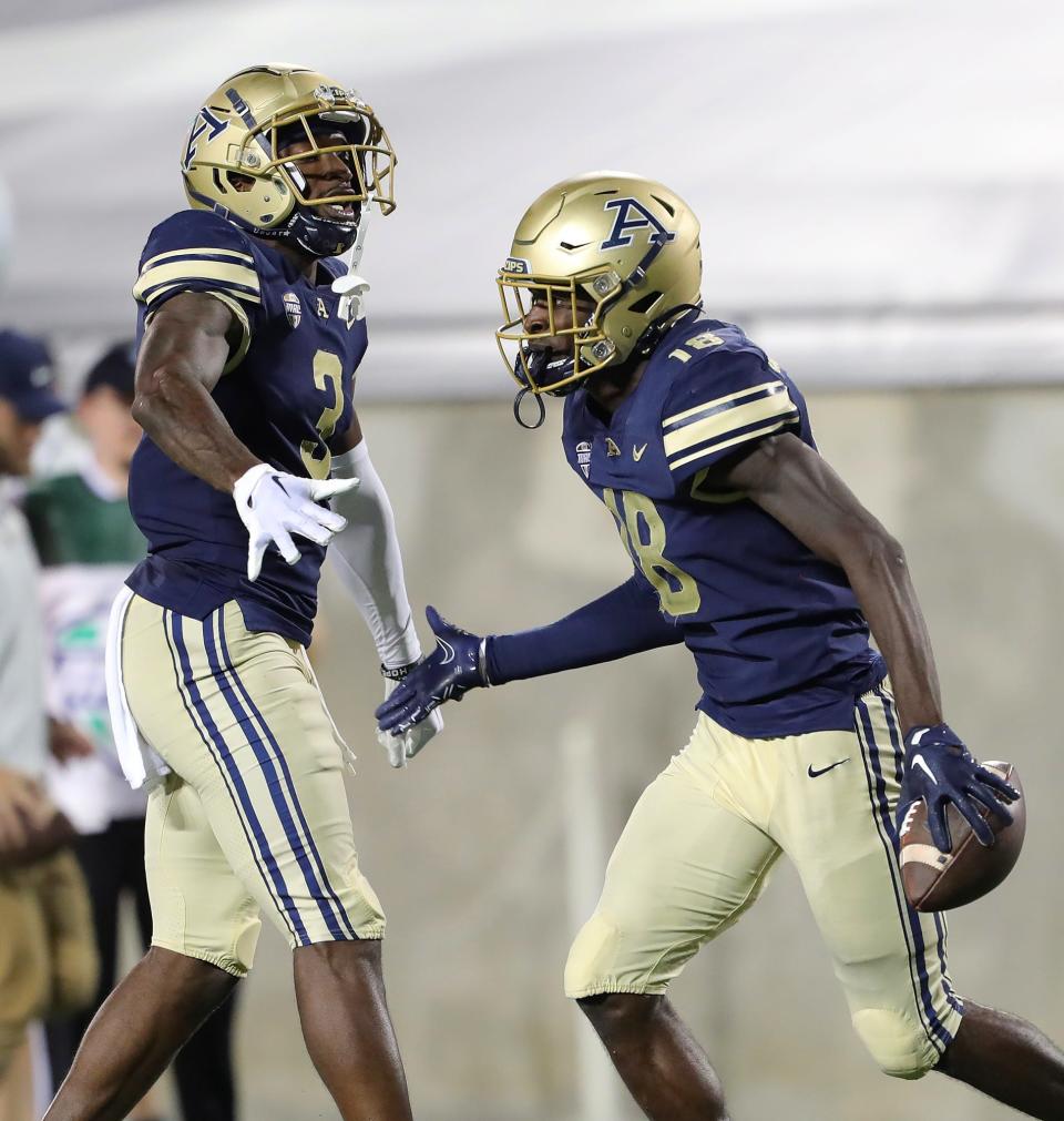 Akron Zips wide receiver Shocky Jacques-Louis (18) celebrates a reception with Akron Zips wide receiver Daniel George (3) during an overtime period of an NCAA football game against the St. Francis (Pa) Red Flash, Thursday, Sept. 1, 2022, in Akron, Ohio.