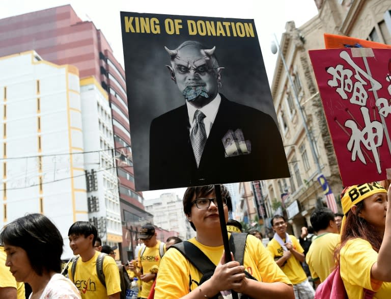 A protester holds a placard criticising Malaysian Prime Minister Najib Razak on the second day of an anti-government rally near Independence Square in Kuala Lumpur on August 30, 2015