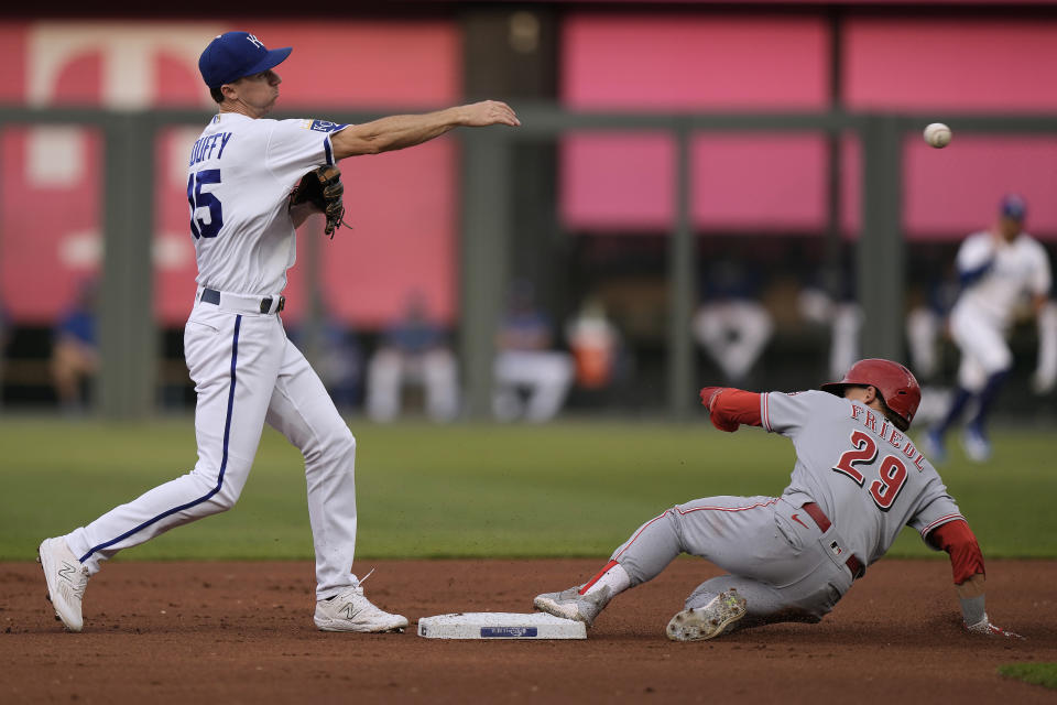 Kansas City Royals second baseman Matt Duffy (15) throws to first for the double play hit into by Cincinnati Reds' Jonathan India after forcing TJ Friedl (29) out at second during the first inning of a baseball game Tuesday, June 13, 2023, in Kansas City, Mo. (AP Photo/Charlie Riedel)