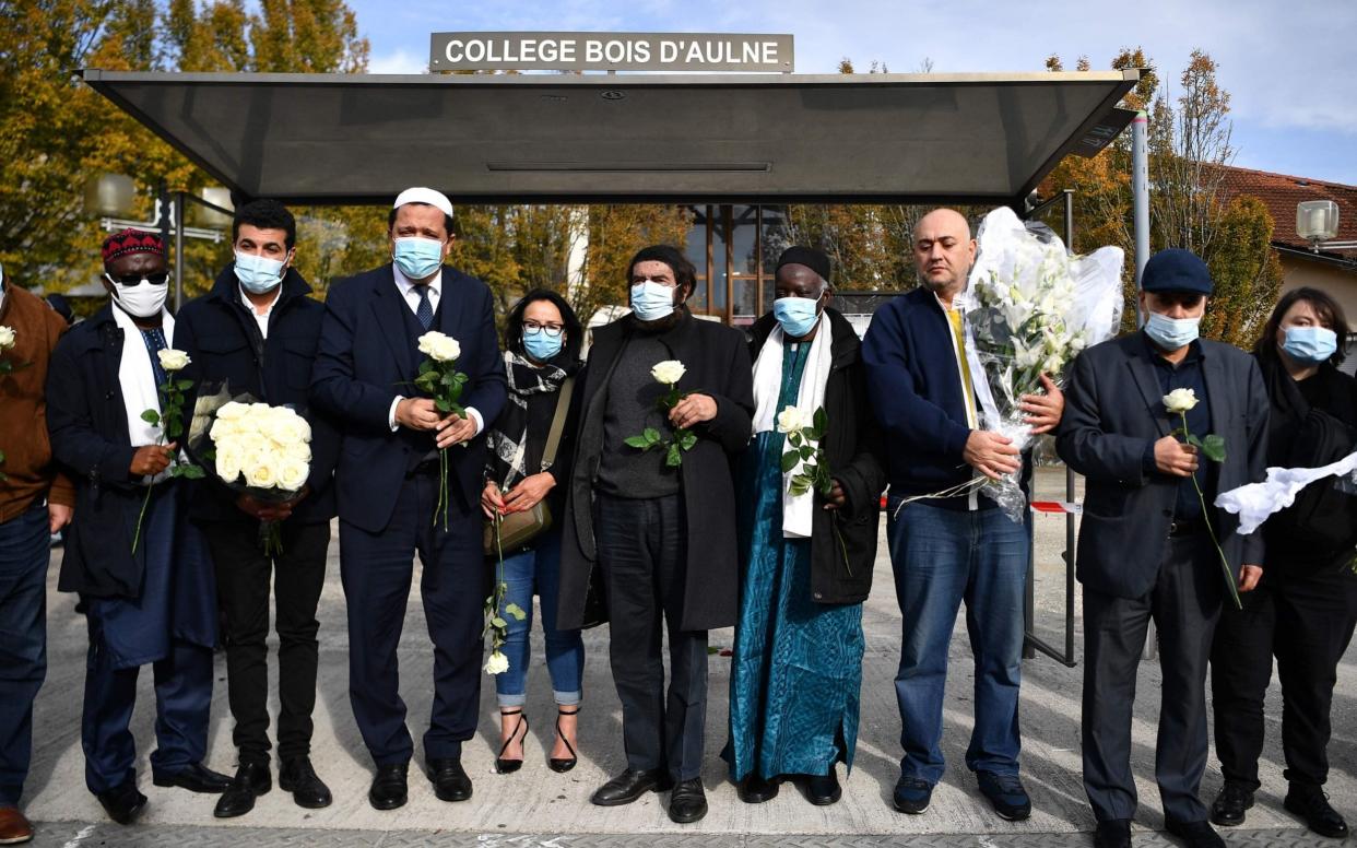 Imam of Drancy Hassen Chalghoumi (3rd L) and French Jewish writer Marek Halter (C) attend a gathering of imams outside the Bois d'Aulne secondary school  - AFP