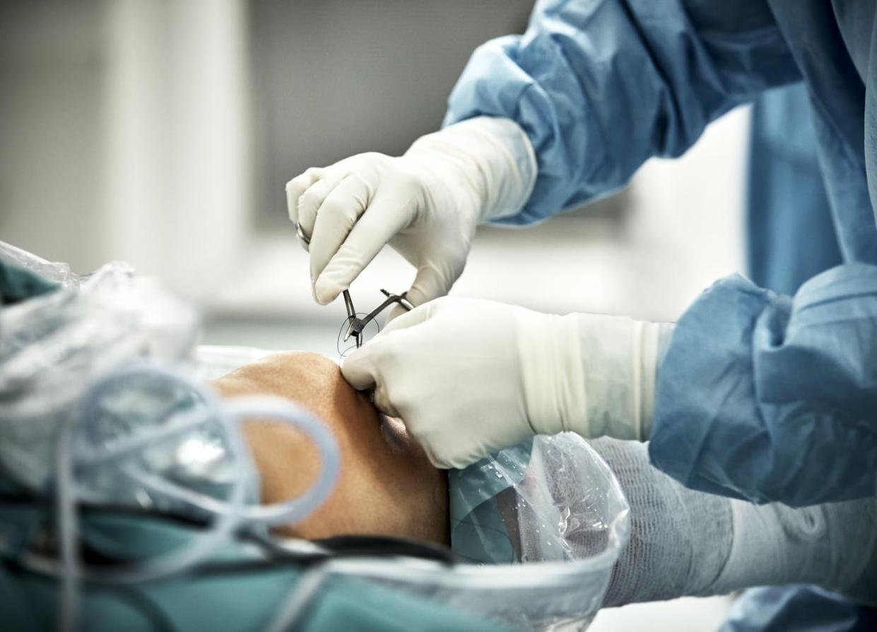 <span class="caption">The price physicians charge for every surgery, checkup or other procedure has a precise formula behind it. </span> <span class="attribution"><a class="link " href="https://www.gettyimages.com/detail/photo/cropped-hands-of-surgeon-stitching-after-royalty-free-image/1010678728" rel="nofollow noopener" target="_blank" data-ylk="slk:Morsa Images/DigitalVision via Getty Images;elm:context_link;itc:0;sec:content-canvas">Morsa Images/DigitalVision via Getty Images</a></span>