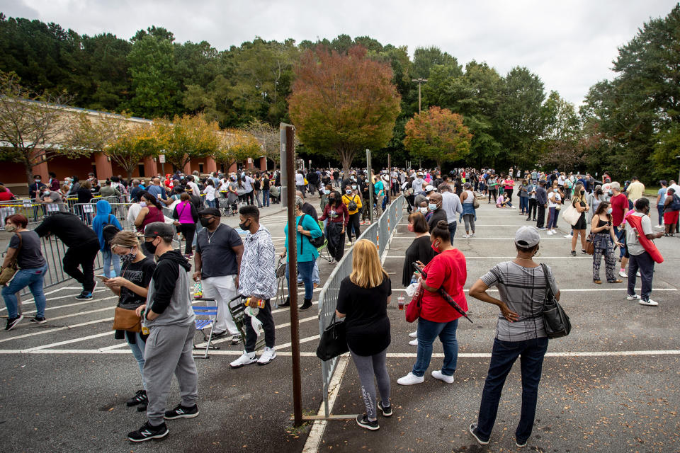 FILE - Hundreds of people wait in line for early voting on Oct. 12, 2020, in Marietta, Ga. According to a bipartisan report released Tuesday, Feb. 6, 2024, that calls for greater transparency and steps to make voting easier, a "tumultuous period of domestic unrest" combined with a complicated and highly decentralized election system has led to a loss of faith in election results among some in the U.S. (AP Photo/Ron Harris, File)