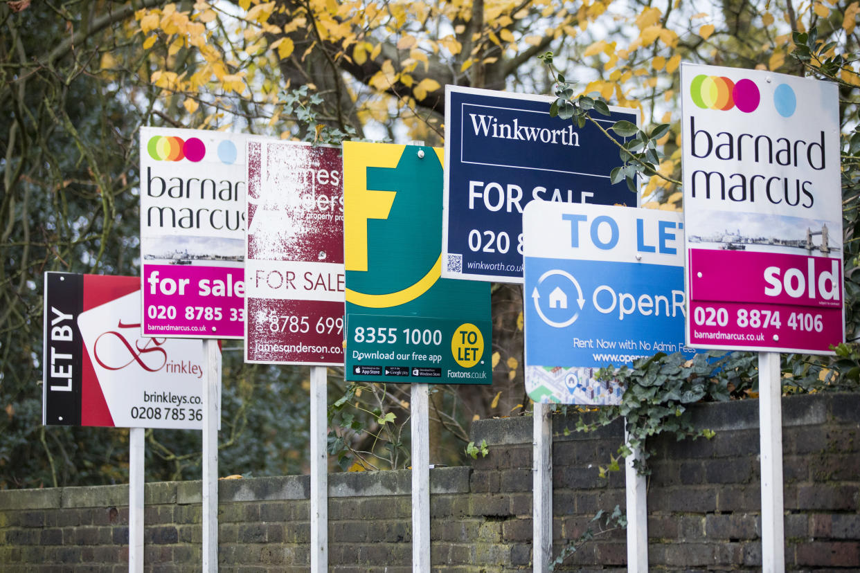 Estate agents' property for sale and to let boards sit attached to a wall. Photo: Jason Alden/Bloomberg