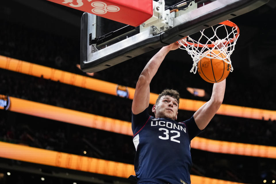 UConn center Donovan Clingan dunks against Gonzaga during the second half of an NCAA college basketball game Friday, Dec. 15, 2023, in Seattle. (AP Photo/Lindsey Wasson)