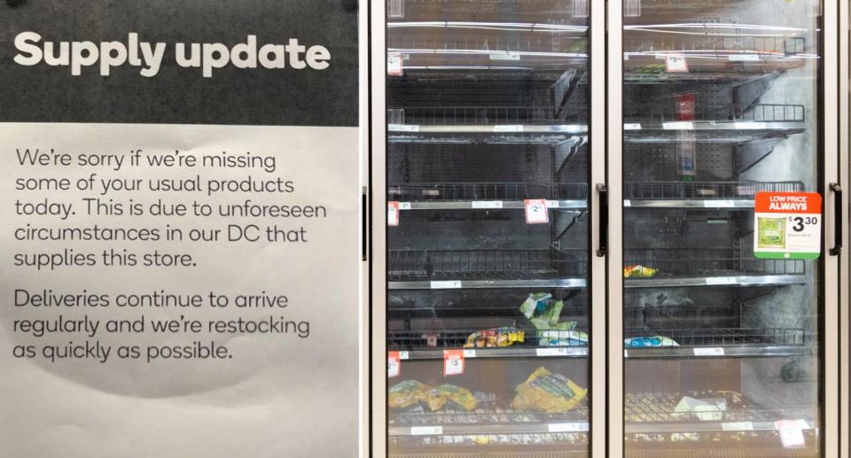 Supply update sign explaining item shortage and photo of empty fridge