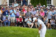 Fans watch as Rickie Fowler chips from the rough during the third round of the Travelers Championship golf tournament at TPC River Highlands, Saturday, June 24, 2023, in Cromwell, Conn. (AP Photo/Frank Franklin II)