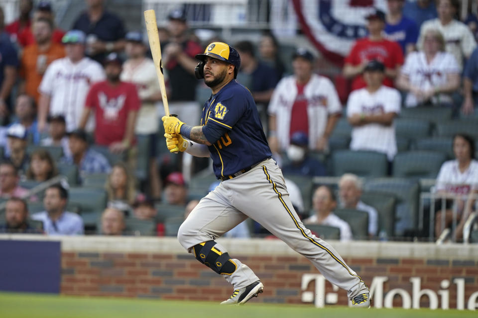 Milwaukee Brewers' Omar Narvaez (10) follows through on his RBI single against the Atlanta Braves during the fourth inning of Game 4 of a baseball National League Division Series, Tuesday, Oct. 12, 2021, in Atlanta. (AP Photo/Brynn Anderson)