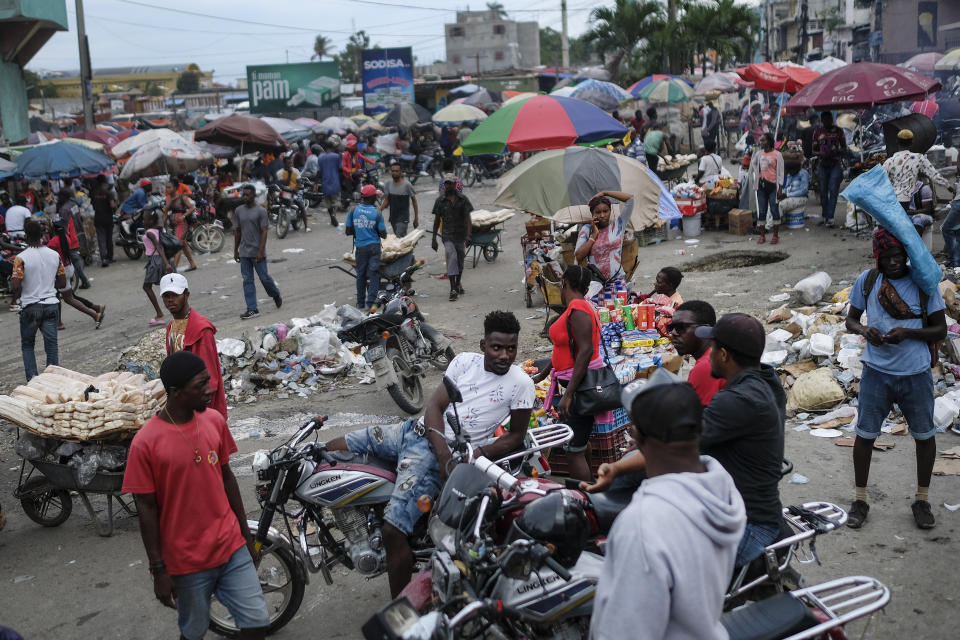 Mototaxi drivers wait for customers during the general strike in Port-au-Prince, Haiti, Monday, Oct. 18, 2021. Workers angry about the nation's lack of security went on strike in protest two days after 17 members of a U.S.-based missionary group were abducted by a violent gang. (AP Photo/Matias Delacroix)