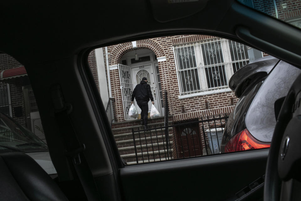 Mohammed Widdi, 31, coordinator of Muslims Giving Back, drops off groceries for a family affected by COVID-19 in the Bay Ridge neighborhood of Brooklyn, New York, on Monday, April 27, 2020. (AP Photo/Wong Maye-E)