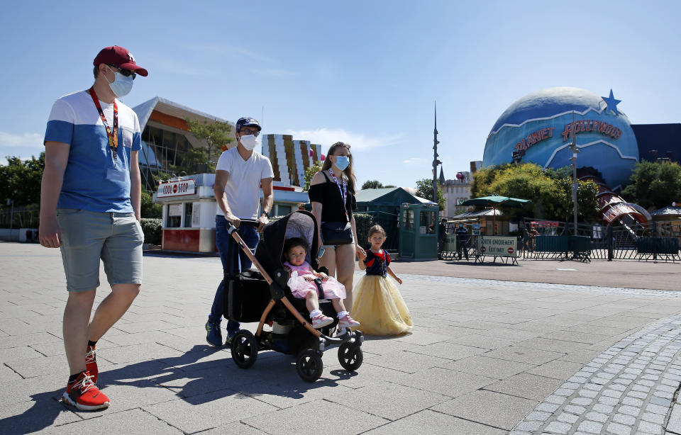 PARIS, FRANCE - JULY 13: People with annual passes wearing protective face masks arrive to visit Disneyland Paris on July 13, 2020 in Marne-la-Vallee, near Paris, France. After four months of closure, the amusement park officially reopens its doors on Wednesday July 15 with compulsory reservations online. The Disneyland Paris and Walt Disney studio parks have been closed since mid-March due to the coronavirus epidemic (COVID 19). (Photo by Chesnot/Getty Images)