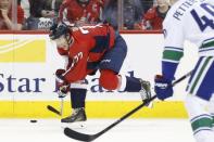 Feb 5, 2019; Washington, DC, USA; Washington Capitals right wing T.J. Oshie (77) passes the puck as Vancouver Canucks center Elias Pettersson (40) defends in the third period at Capital One Arena. Mandatory Credit: Geoff Burke-USA TODAY Sports