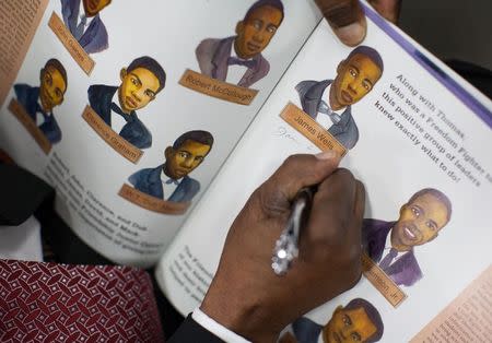 James F. Wells writes his signature on a book about the "Friendship Nine", a group of black civil rights protesters arrested for trespassing in 1961, in Rock Hill, South Carolina January 28, 2015. REUTERS/Jason Miczek