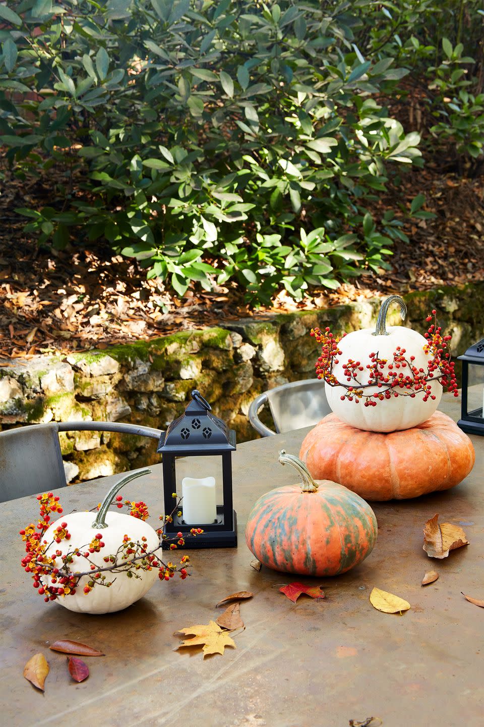 <p>Don't miss the opportunity to show off your style for an outdoor Halloween dinner party. Scatter a few pumpkins on your table, and pick a few to decorate with bittersweet wreaths.</p>